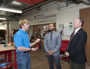 Toyota's Javier Moreno and Michael Rouse toured the Plano ISD Academy High School following the school board recognition. They are pictured with third year learner Colin McMahn, president of the National Honor Society and member of the school's Spartan club, a group of students who do physical training, post colors daily and conduct practice drills and marching routines.